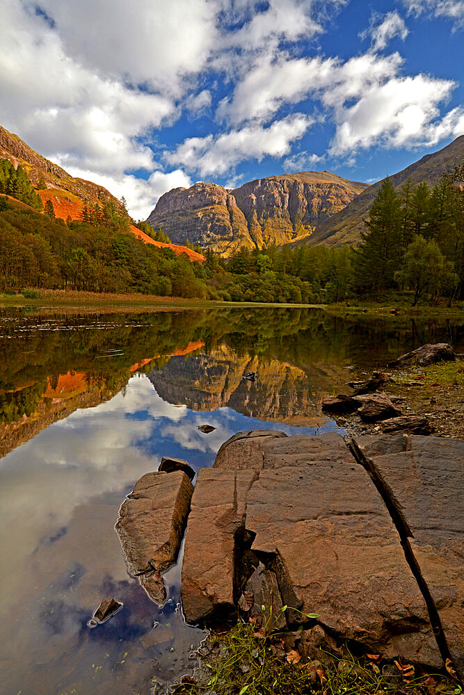 The rugged peak of Aonach Dubh reflected in Torren Lochan, Glencoe, Argyll and Bute, Scotland, United Kingdom, Europe