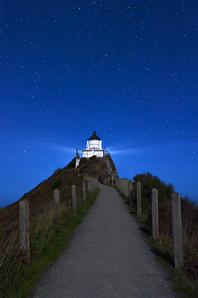 Nugget Point lighthouse under star filled sky, Kaka Point, Otago, South Island, New Zealand, Pacific