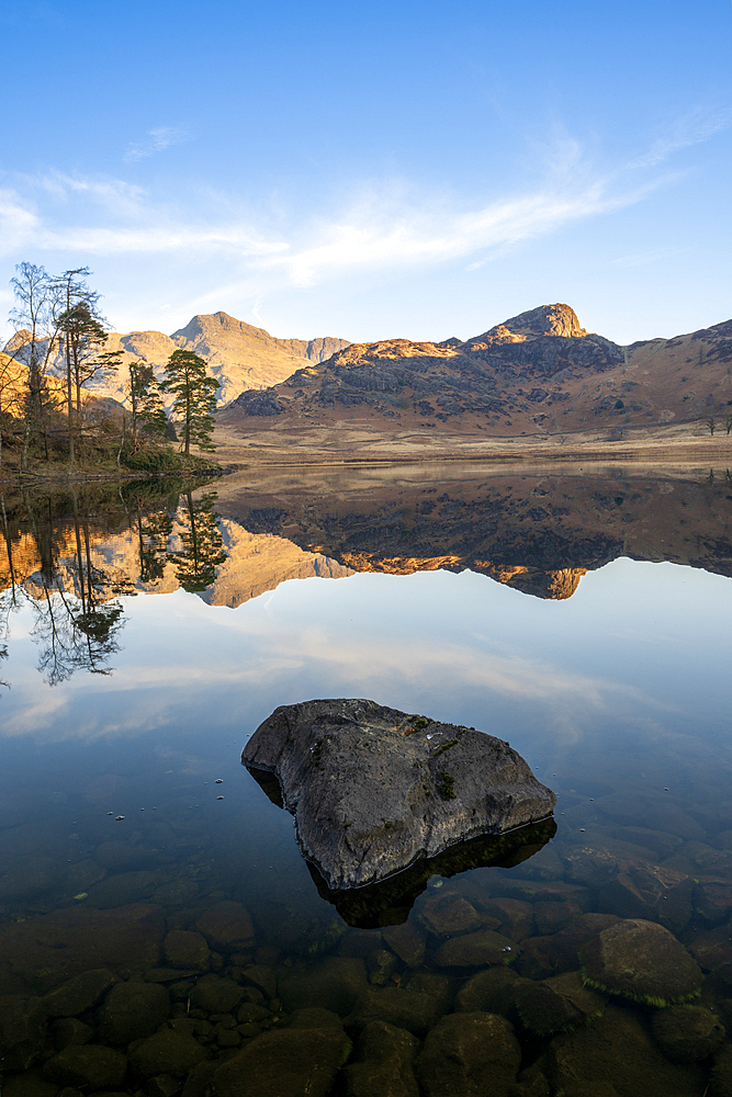 Blea Tarn with mirror conditions, spring, Lake District National Park Cumbria