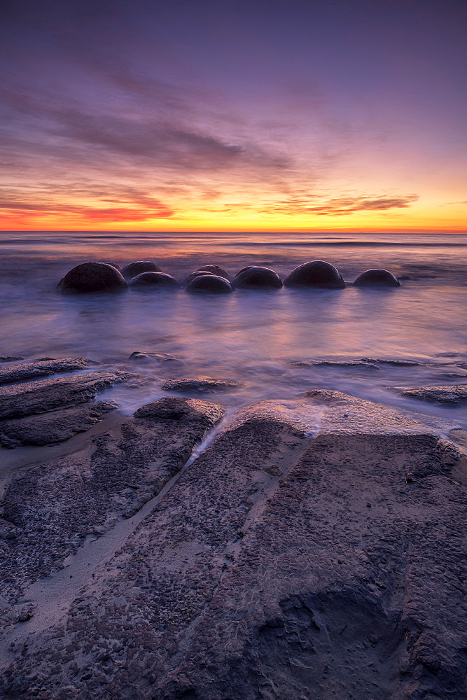 Epic sunrise at Moeraki Beach with the Moeraki Boulders, Moeraki Beach, Otago, South Island, New Zealand, Pacific