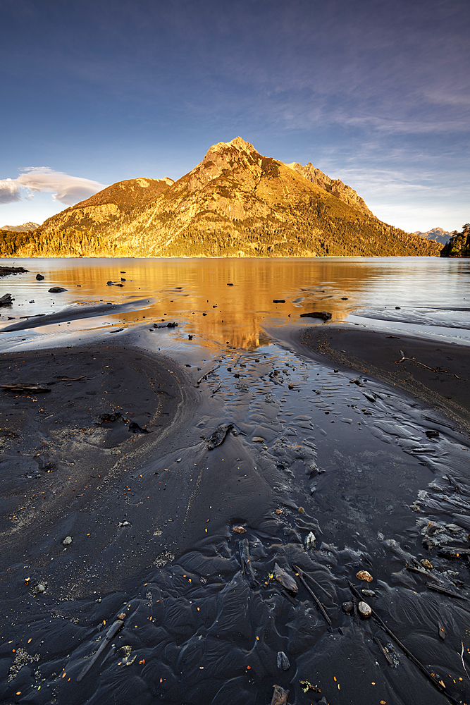 Black lava beach with reflected mountain, Barilochie, Patagonia, Argentina, South America