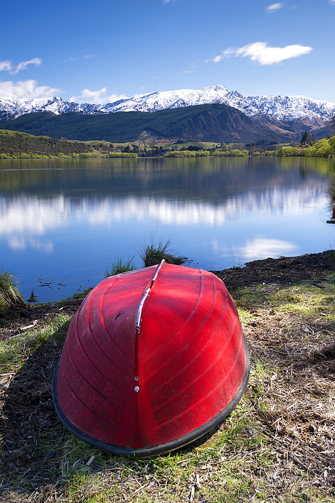 Snow capped mountains reflected in Lake Hayes, Wakatipu Basin in Central Otago, South Island, New Zealand, Pacific