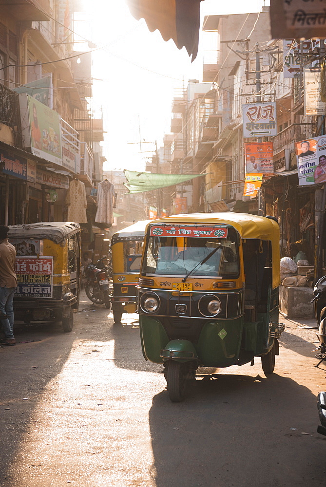 Tuk Tuks at sunset ride through the tiny streets of Jodhpur, Rajasthan, India, Asia