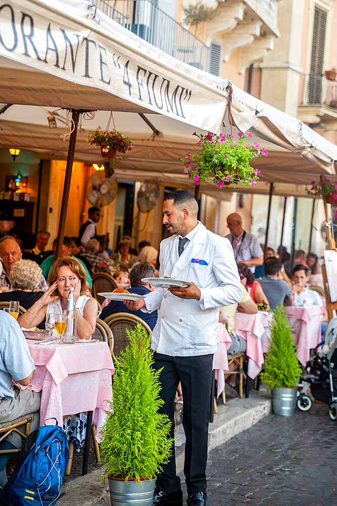 Waiter serving at outdoors restaurant table, Piazza Navona, Rome, Lazio, Italy, Europe