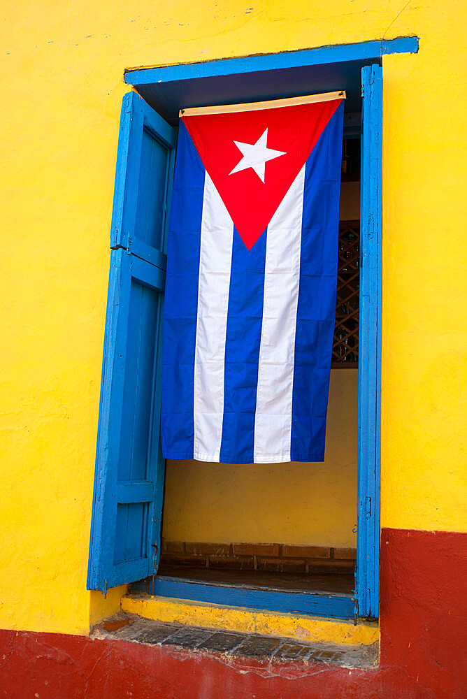 Cuban flag in doorway, Trinidad, Sancti Spiritus, Cuba, West Indies, Central America