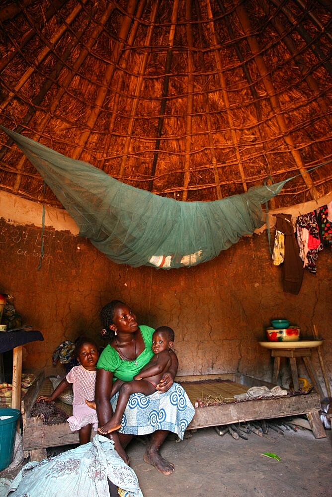 Woman and children in an african hut.