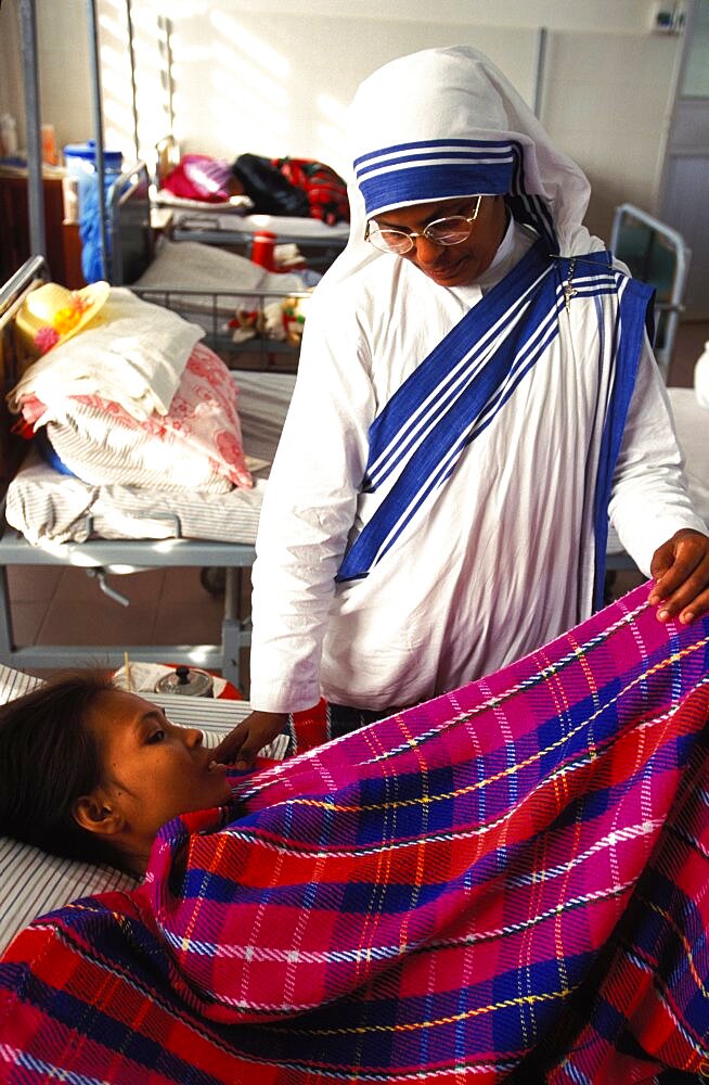 Cambodia, Phnom Penh, Missionaries of Charity, Sister of mercy attending to patient