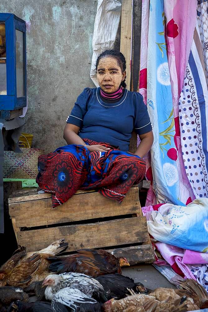 Chicken seller, woman with traditional face mask,saleswoman, market, Morondava, Madagascar