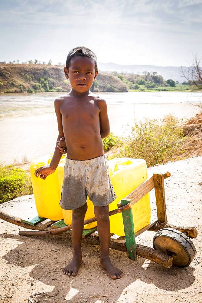 Child working in the distribution of water in Containers, Morondava, Madagascar