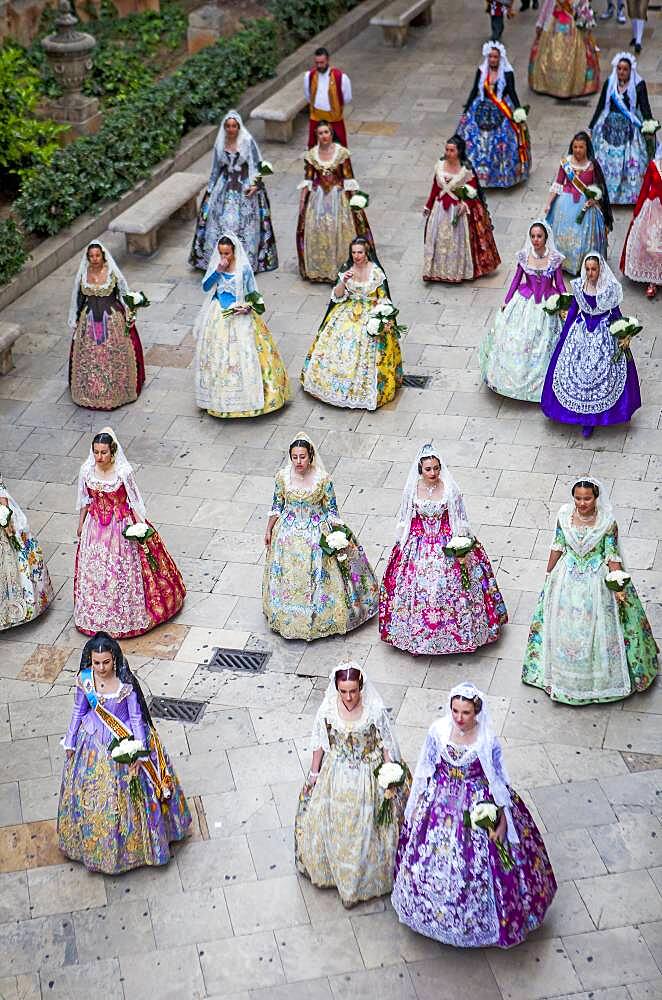 Flower offering parade,People with Floral tributes to `Virgen de los desamparados��, Fallas festival,carrer del Micalet street,Valencia