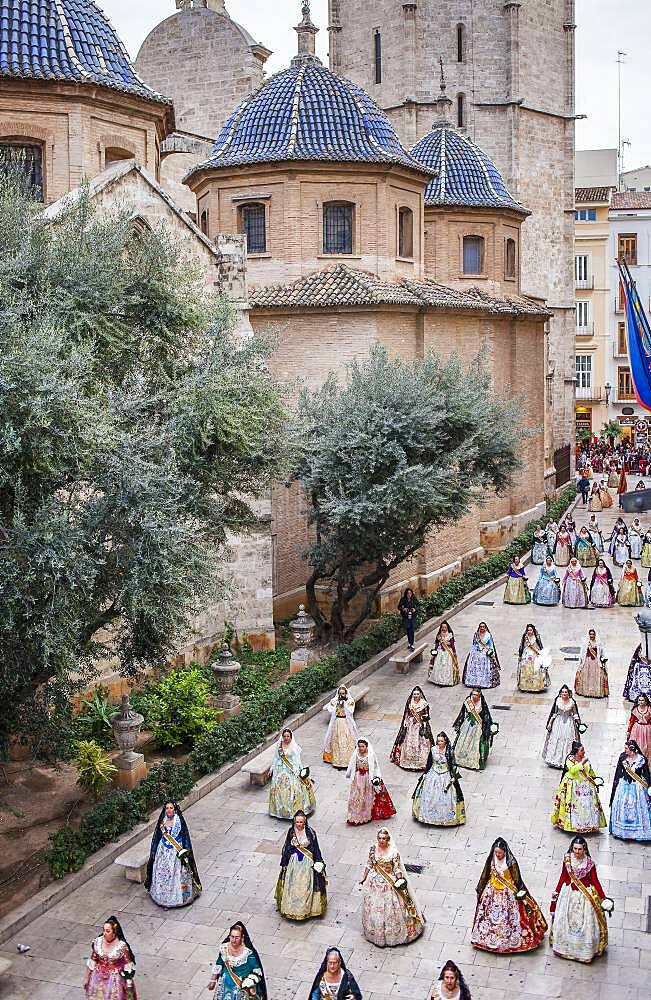 Flower offering parade,People with Floral tributes to `Virgen de los desamparados��, Fallas festival,carrer del Micalet street,Valencia