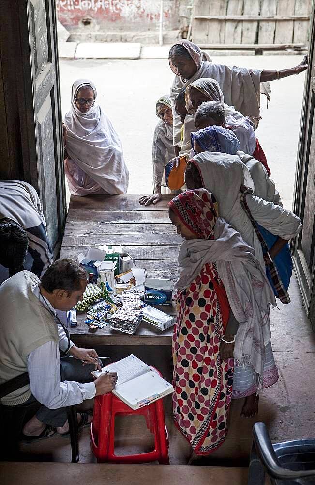 Dr.Ghopal;  Doctor of NGO SOS Woman examining widows, Vrindavan, Mathura district, India