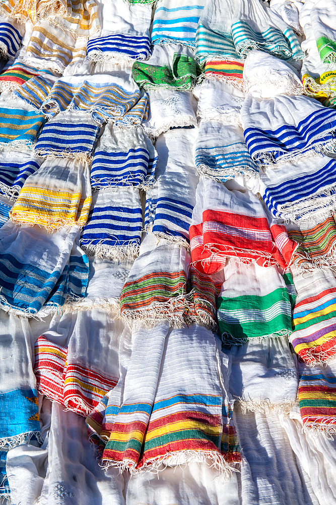 Scarves and textiles layered on top of one another for sale, Debre Berhan, Ethiopia