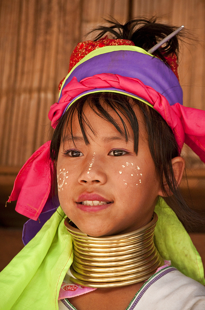 Young girl of the Karen hill tribe wearing traditional neck coil at Baan Tong Luang, a village of Hmong people in Chiang Mai Province, Thailand.