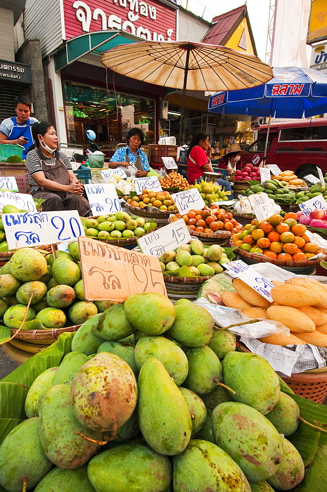 Fruit vendors at Pratu Chiang Mai morning market in Chiang Mai, Thailand.