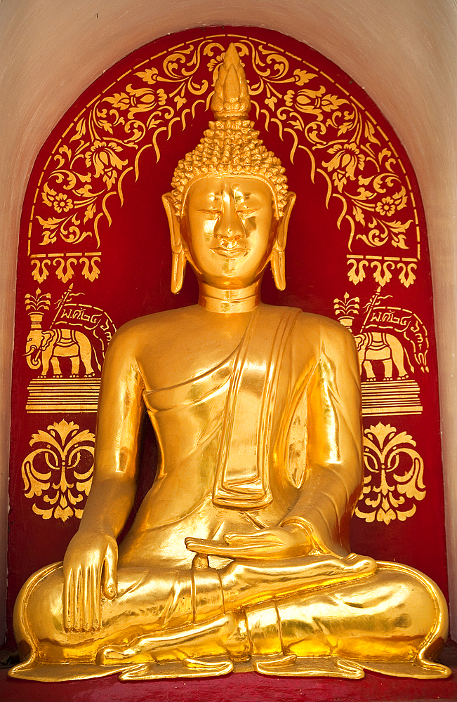 Golden Buddha statue at Wat Fon Soi Buddhist temple in Chiang Mai, Thailand.
