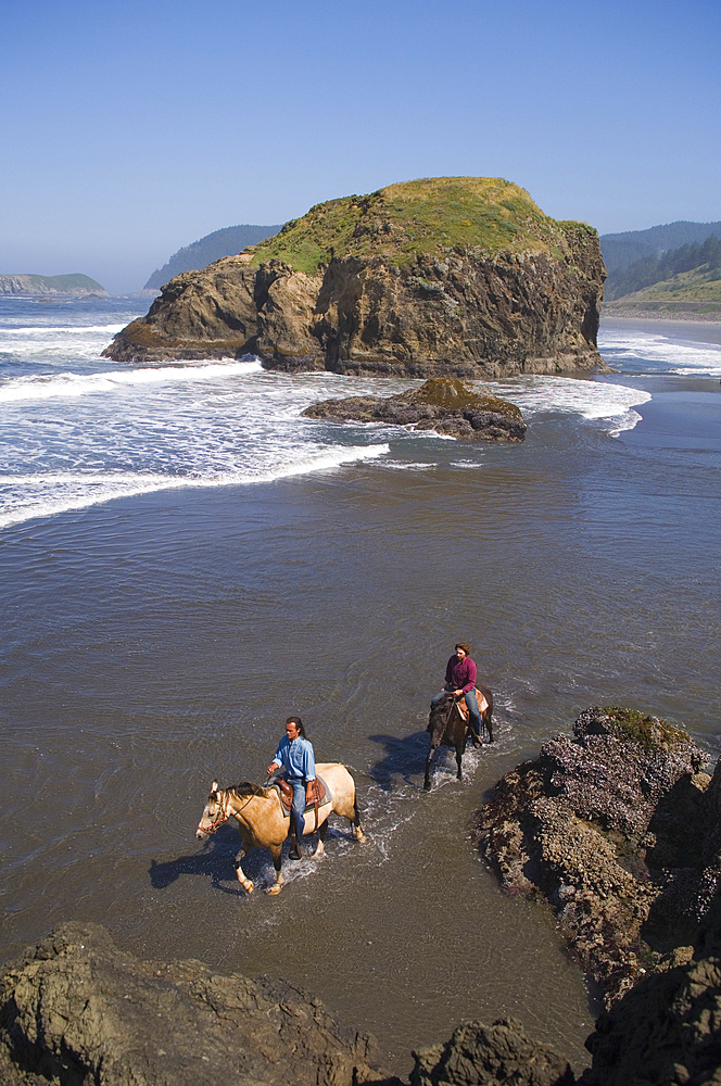 Horseback riding on the beach at the Myers Creek area of Pistol River State Park, Samuel H. Boardman State Scenic Corridor, Oregon Coast.