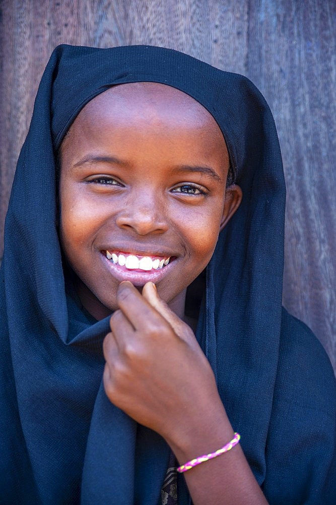 Funy swahili girl portrait in the strees of the city town of Lamu in Kenya