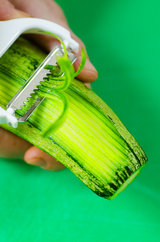 macro shot of a zucchini being peeled