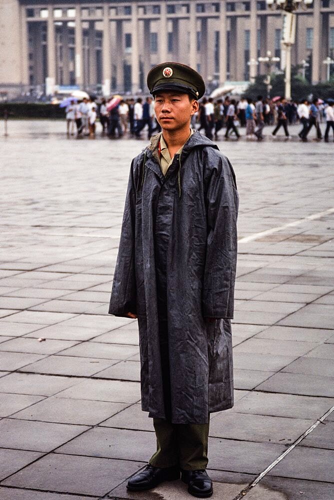 A soldier stands guard in Tiananmen Square on a rainy day in Beijing, China.