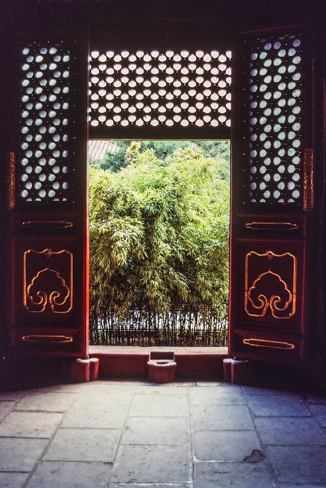 Looking out of a building in the Lama Temple comples, a Buddhist temple in Beijing, China.