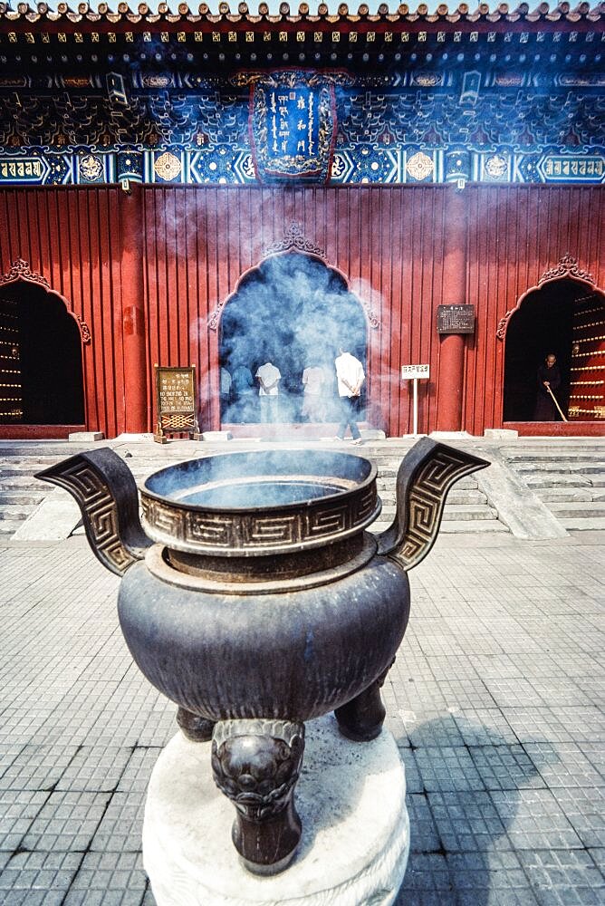 A large bronze censor of incense burner in front of the Lama Temple, a Buddhist temple in Beijing, China.