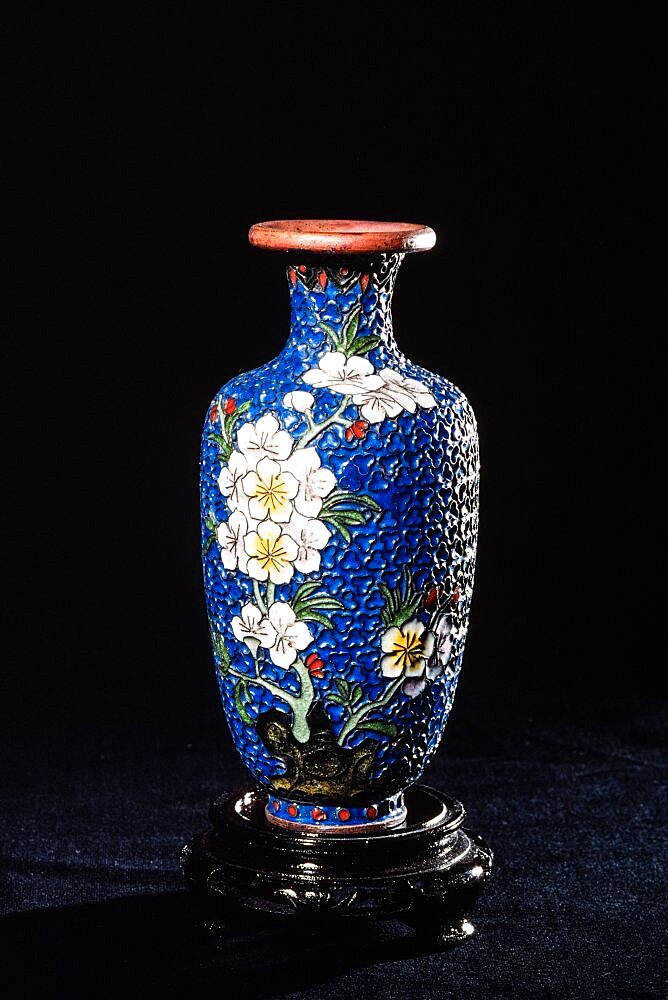 A cloisonne vase partially filled with enamel after the first firing in a cloisonne workshop in Beijing, China.