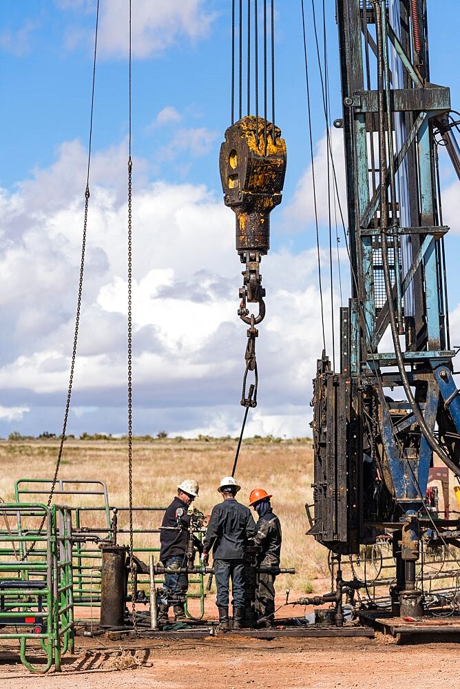 The well service crew on a workover rig works on an oil well to try to bring it back into service.