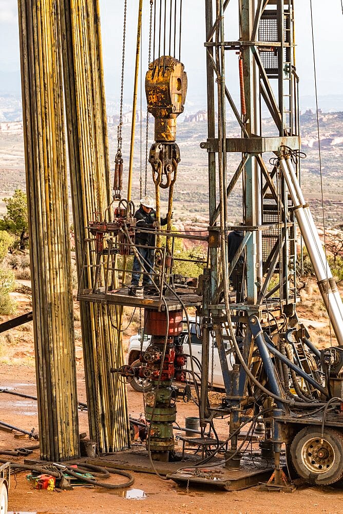 The well service crew on a workover rig works on an oil well to try to bring it back into service.