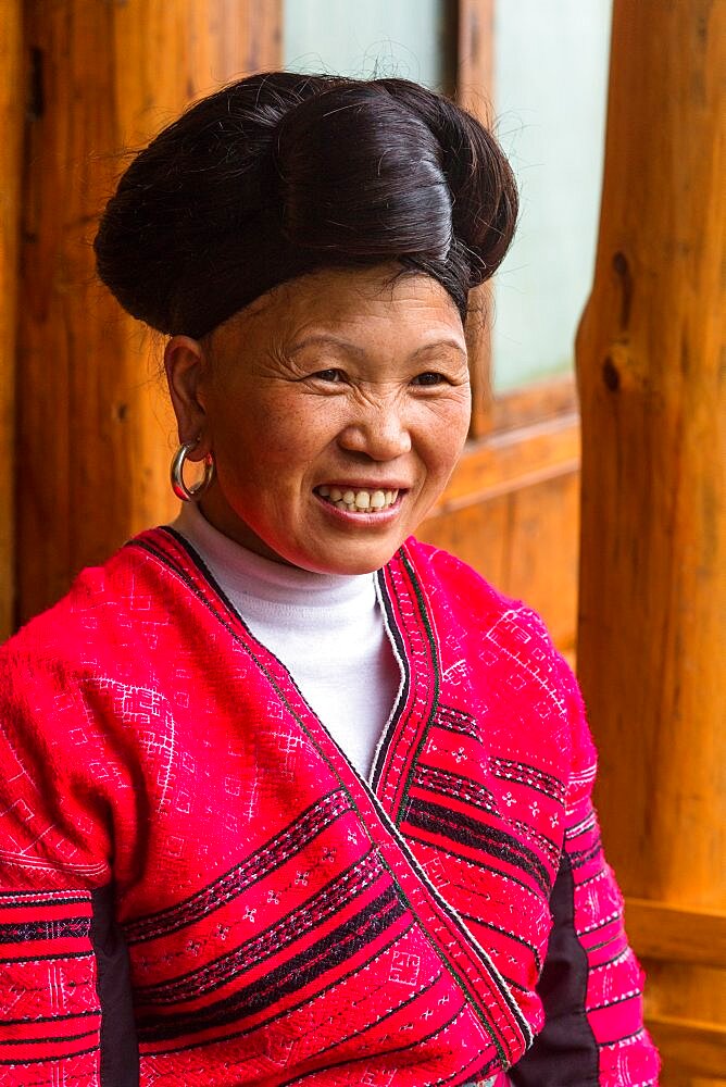 A woman of the Red Yao ethnic minority in traditional attire at the Jinkeng rice terraces, Longshen, China.