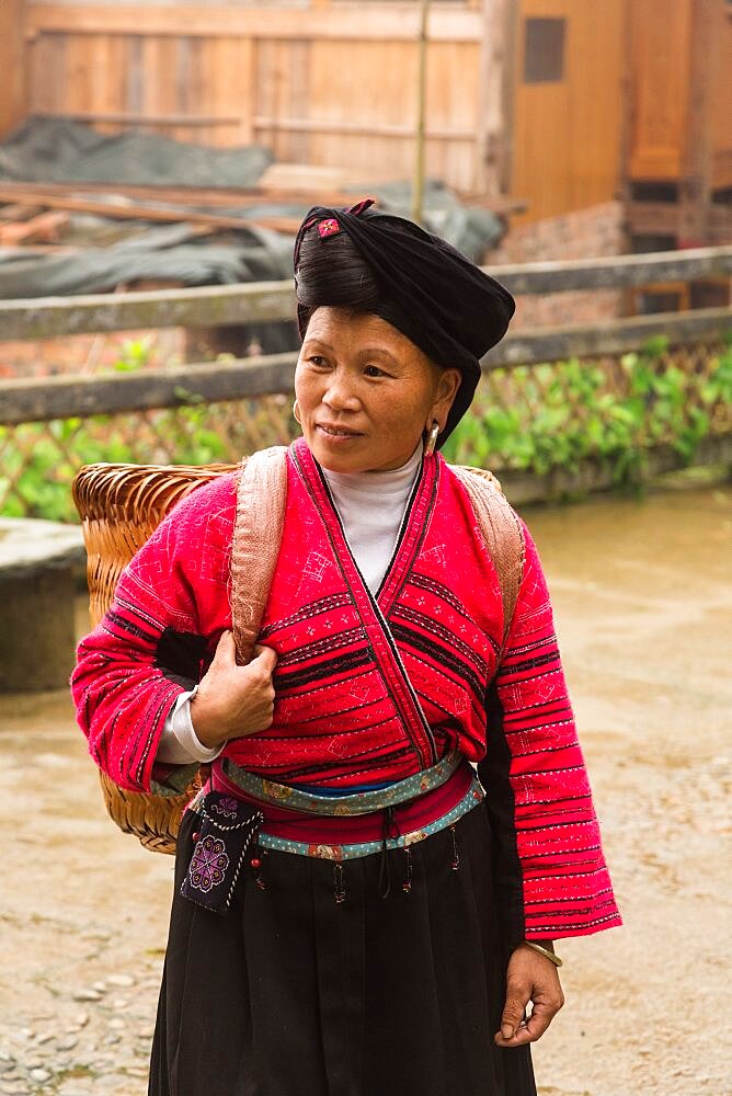 A woman of the Red Yao ethnic minority in traditional attire at the Jinkeng rice terraces, Longshen, China.