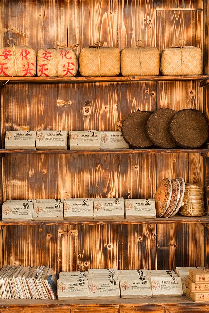 Anhua Dark Tea, Fu Brick Tea and Pu'er Tea disks for sale in a shop in the ancient town of Furong, China.