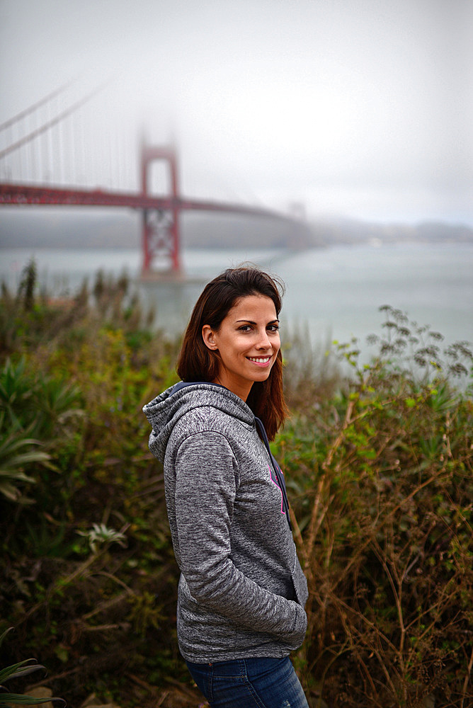 Young woman and Golden Gate Bridge, San Francisco,