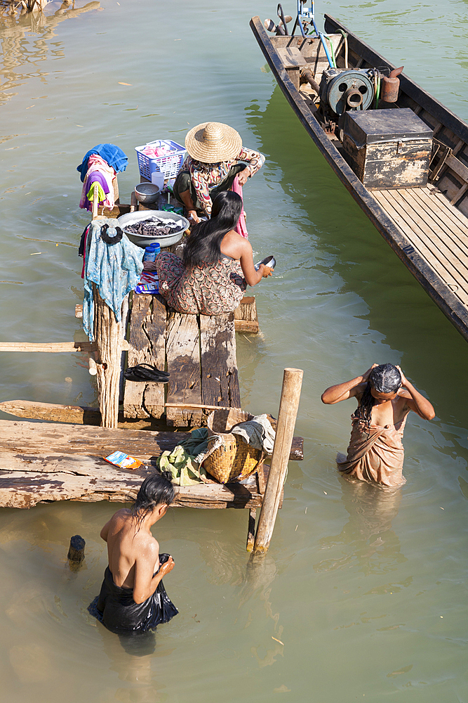 Women washing themselves in Inle Lake, near Indein Village, Shan State, Myanmar, (Burma)