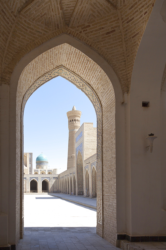 Kalon Mosque courtyard, also known as Kalyan Mosque, Kalon Minaret and Mir-i Arab Madrasah behind, Bukhara, Uzbekistan