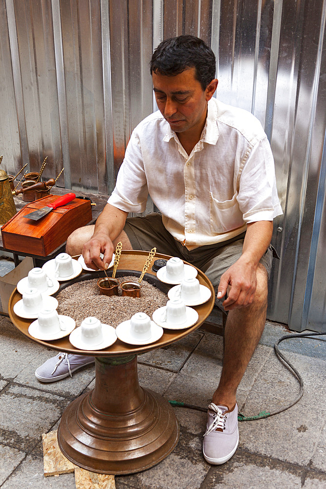 Man making fresh coffee in a street, Beyoglu, Istanbul, Turkey