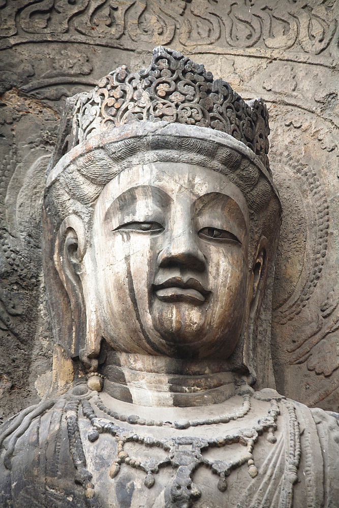 Carved Buddha statue, Fengxian Temple, Longmen Grottoes and Caves, Luoyang, Henan Province, China, Tang Dynasty