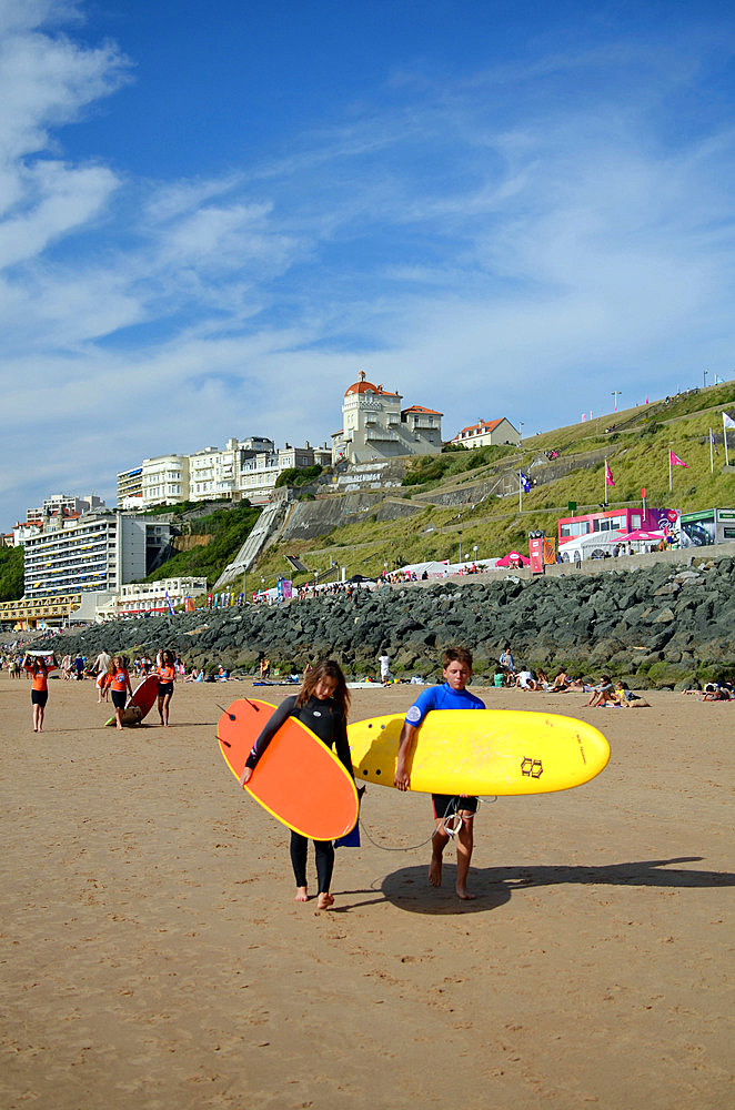 Surfers on Cote des Basques beach at sunset, Biarritz