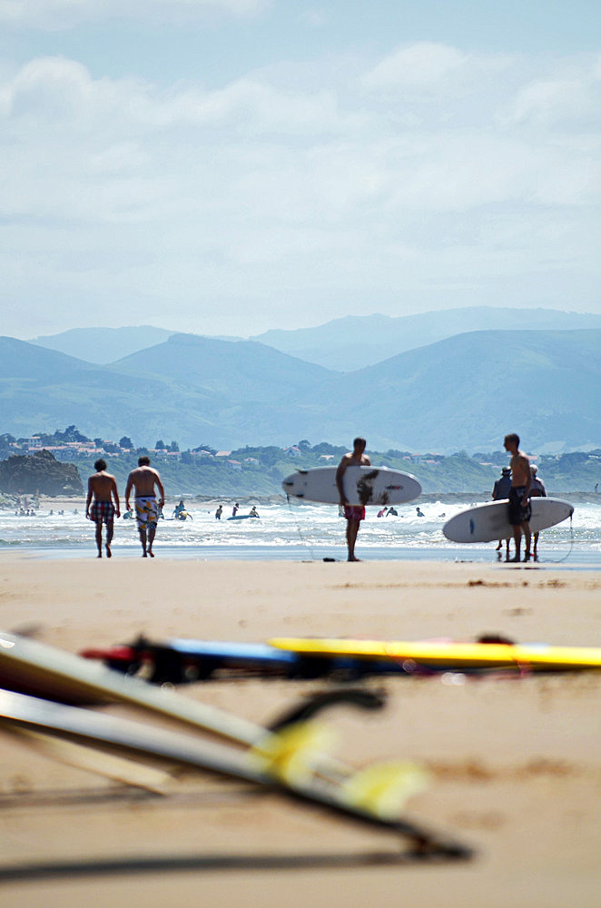 Surfers on Cote des Basques beach at sunset, Biarritz