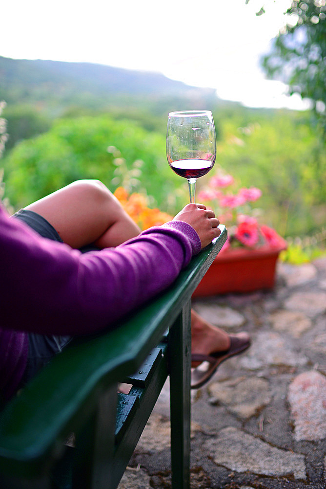 Young woman enjoys a cup of wine