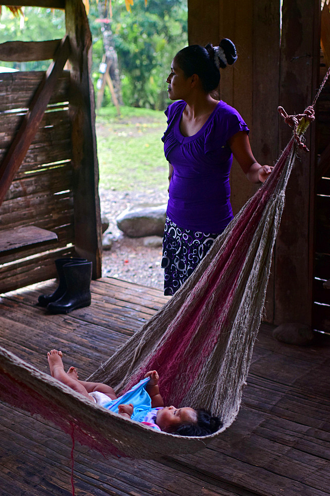 Bribri young mother (Karina) rocking hammock with baby (Simea), A day with the Bribri, indigenous people in Lim?n Province of Costa Rica,