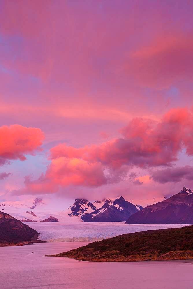 Pink skies before sunrise over the Perito Moreno Glacier in Los Glaciares National Park near El Calafate, Argentina.  A UNESCO World Heritage Site in the Patagonia region of South America.