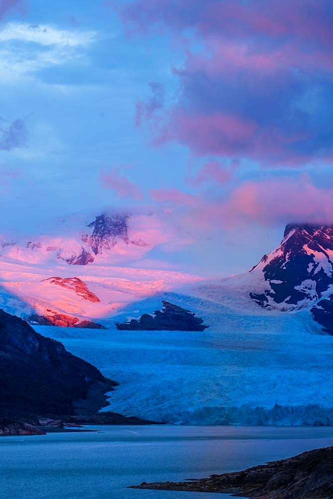 A pastel sunrise over the Perito Moreno Glacier in Los Glaciares National Park near El Calafate, Argentina.  A UNESCO World Heritage Site in the Patagonia region of South America.