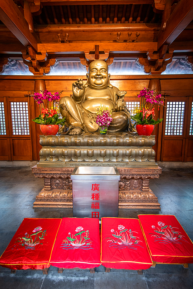 A statue in the Jing'an Temple surrounded by generous offerings, Shanghai, China