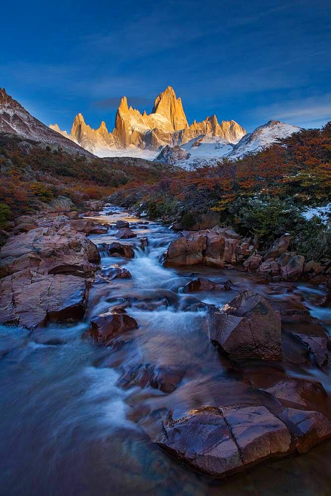 The Fitz Roy Massif at the first light of sunrise.  Los Glaciares National Park near El Chalten, Argentina.  A UNESCO World Heritage Site in the Patagonia region of South America.  Mount Fitz Roy is in the tallest peak in the center.  The creek in the foreground is the Arroyo del Salto.