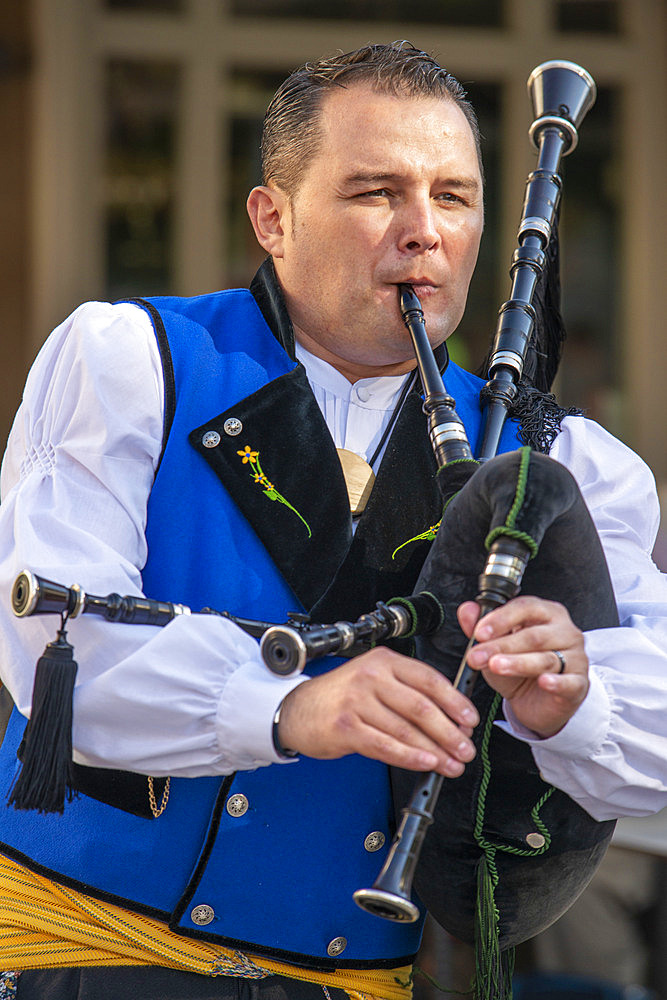 Traditional music of Galicia. Gaiteiros Rio de anxo. Old Town, Santiago de Compostela, UNESCO World Heritage Site, Galicia, Spain.

Bagpipes are a woodwind instrument using enclosed reeds fed from a constant reservoir of air in the form of a bag. The Scottish Great Highland bagpipes are the best known examples in the Anglophone world, but people have played bagpipes for centuries throughout large parts of Europe. The term bagpipe is equally correct in the singular or the plural, though pipers usually refer to the bagpipes as the pipes, a set of pipes or a stand of pipes.