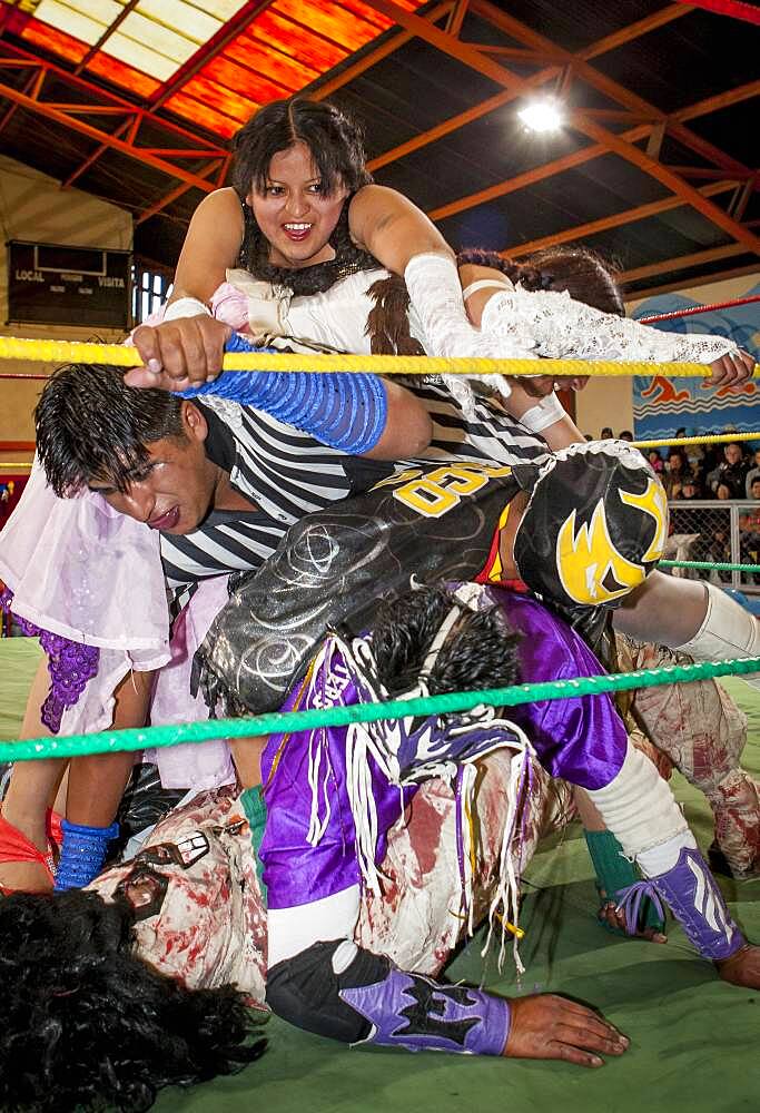 Lucha Libre. Julieta and Celia la Simpatica during a crazy combat, agaist males wrestlers, Sports center La Ceja, El Alto, La Paz, Bolivia