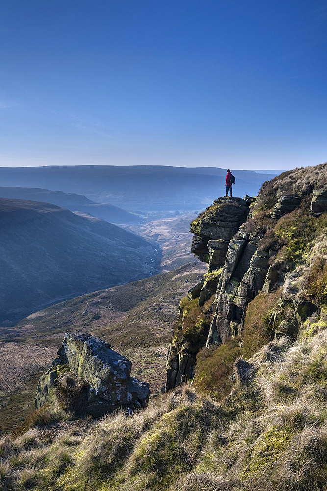 Walker looking over Crowden Great Brook valley from Laddow Rocks, Peak District National Park, Derbyshire, England, United Kingdom, Europe