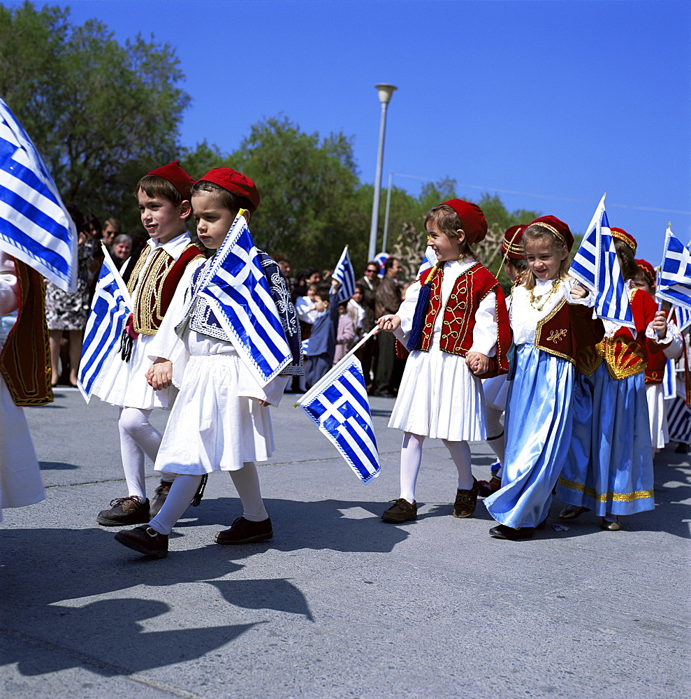 Children in national dress carrying flags, Independence Day celebrations, Greece, Europe