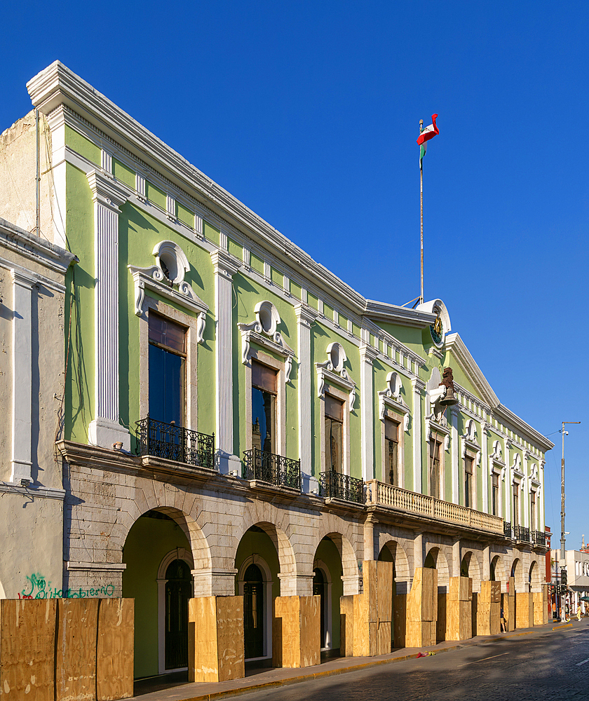 Mexican flag flying above Governor's Palace government building (Palacio de Gobierno), Merida, Yucatan State, Mexico, North America